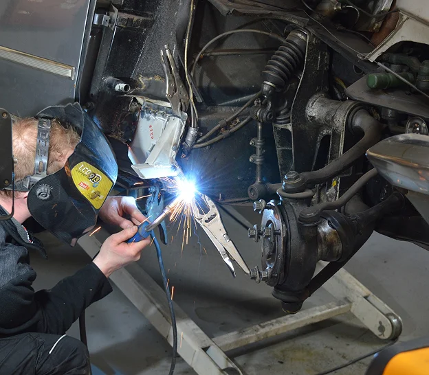 carrossier automobile une pièce de voiture sur le châssis, étincelles vives à Gargenville près de Mantes-la-Jolie dans les Yvelines 78